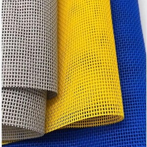 May include: Three rolls of mesh fabric featuring a grid pattern. The left roll is light gray, the center roll is bright yellow, and the right roll is deep blue. Each piece of material displays a consistent, open-weave square hole structure.