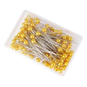 May include: A clear plastic box filled with numerous sewing pins. Each pin has a silver shaft and a round, golden-yellow head. The pins are densely packed, suggesting a large quantity for sewing or crafting projects.