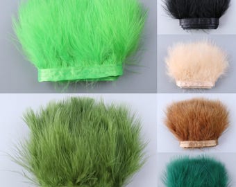 May include: Assortment of feather trim in various colors, including green, black, beige, brown, and teal. Each trim is approximately 1 inch wide and features a satin ribbon backing.