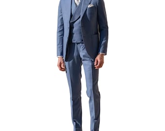 May include: A three-piece light blue suit. The suit includes a blazer, vest, and trousers. The blazer has a notched lapel and a pocket square. The vest has a unique lapel design. The trousers are tailored with a straight leg. The suit is worn with a white shirt and a light-colored tie.