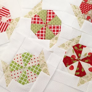 May include: A collection of handmade fabric squares with a Christmas theme. Each square features a different design with red, green, and white colors. The designs include a pinwheel, a star, and a candy cane.