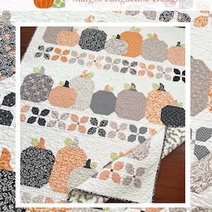 May include: A quilt featuring a pattern of pumpkins in shades of orange, gray, and black. The quilt is made with a white background and has a border of green and white floral fabric. The quilt is titled "Pumpkin Harvest" and the website "www.thepatternbasket.com" is displayed below the title.