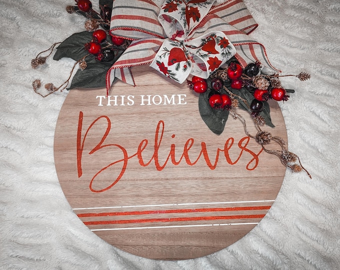 Featured listing image: This Home Believes Christmas door hanger