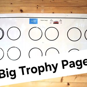 May include: A white board with the text "Big Trophy Page" and a grid of nine circles. Each circle has a black outline and is empty. The top left circle has a small image of a trophy inside.