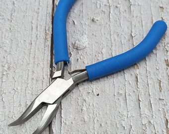 May include: Blue handled pliers with a long, thin, pointed jaw. The pliers are made of metal and have a blue rubber grip.
