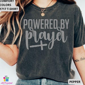 May include: A white ceramic mug with a black handle and the text "But First, Coffee" in a handwritten style. The mug is on a white surface. The mug is approximately 4 inches tall.