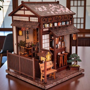 May include: A detailed wooden miniature Japanese tea house model. The model features a brown exterior with a tiled roof, paper screen windows, and a small bench. Cherry blossom accents adorn the roof. The interior includes miniature furniture and decor.