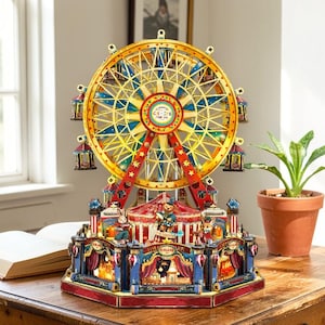May include: A decorative Ferris wheel with a circus theme. The wheel is gold and red, with blue and yellow accents. The base features a circus tent and various animated figures. The text "The Funland Park" is visible on the base.