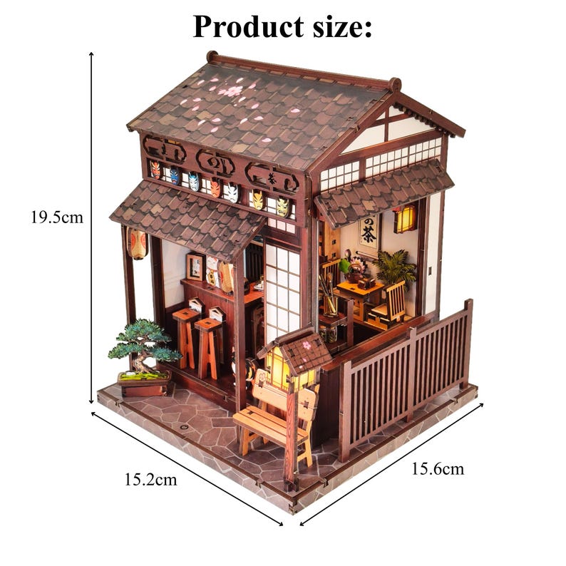 May include: A miniature Japanese-style house model with a brown tiled roof and white walls. The model features a small bench, a bonsai tree, and a sign that reads "Product size:" with dimensions of 19.5 cm high, 15.2 cm wide, and 15.6 cm deep.