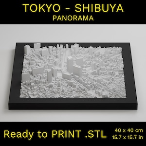 May include: A 3D printed model of the Tokyo Shibuya skyline, ready to print. The model is 40 cm by 40 cm and is printed in white plastic.