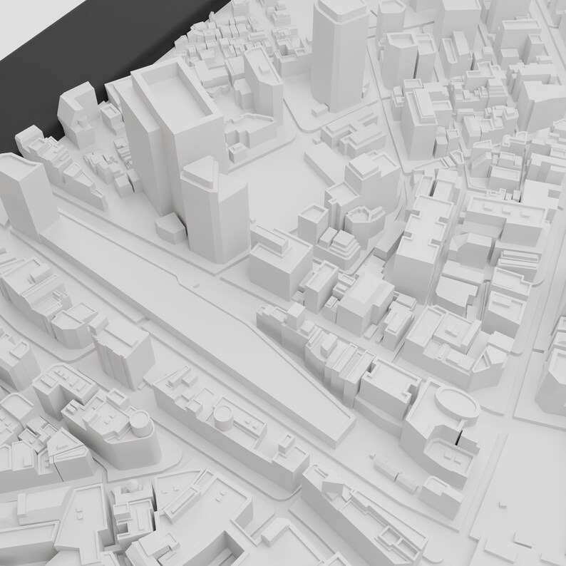 May include: A white 3D model of a city with buildings and streets. The model is made of paper or cardboard and is a miniature representation of a city.