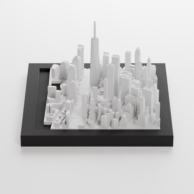 May include: A white 3D model of a city skyline, including skyscrapers and buildings, displayed on a black square base.