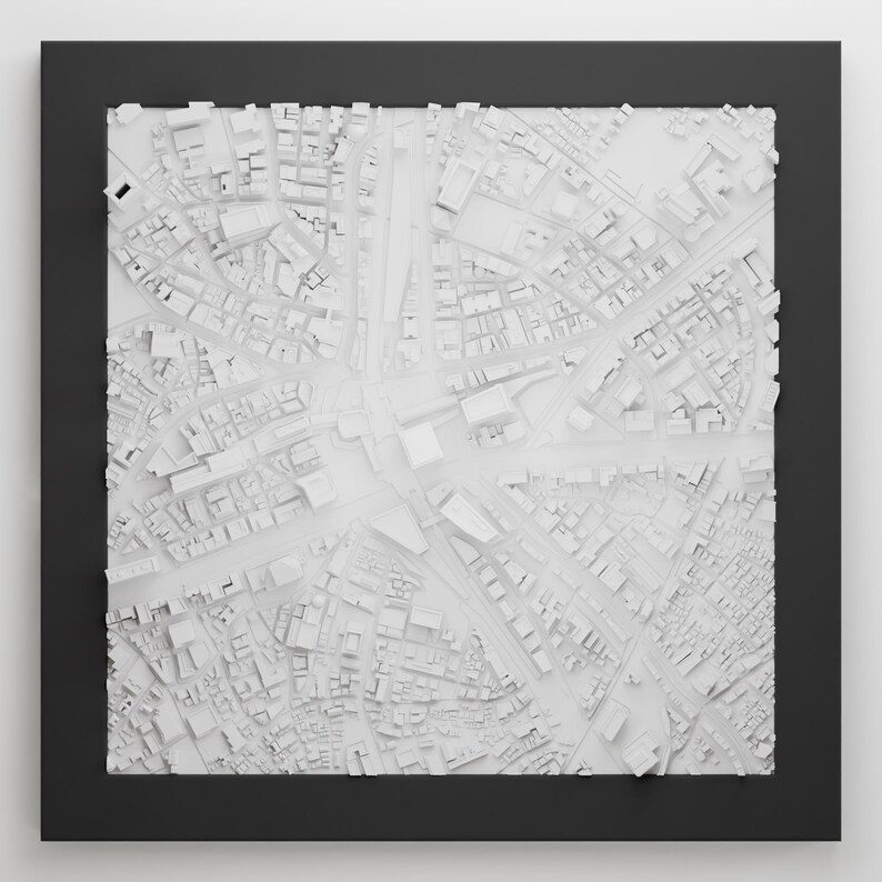 May include: A white 3D model of a city, with buildings and streets, framed in black.