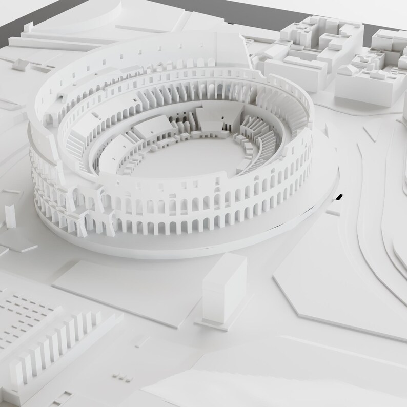 Puede incluir: Un modelo 3D blanco del Coliseo romano, un gran anfiteatro con una arena circular rodeada de gradas. El modelo est&aacute; detallado con arcos y columnas.