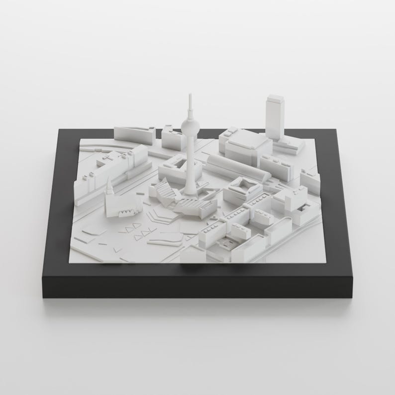 以下が含まれることがあります： 白い3Dモデルの都市のシルエットで、高い塔と周囲の建物があります。モデルは黒いベースに表示されています。