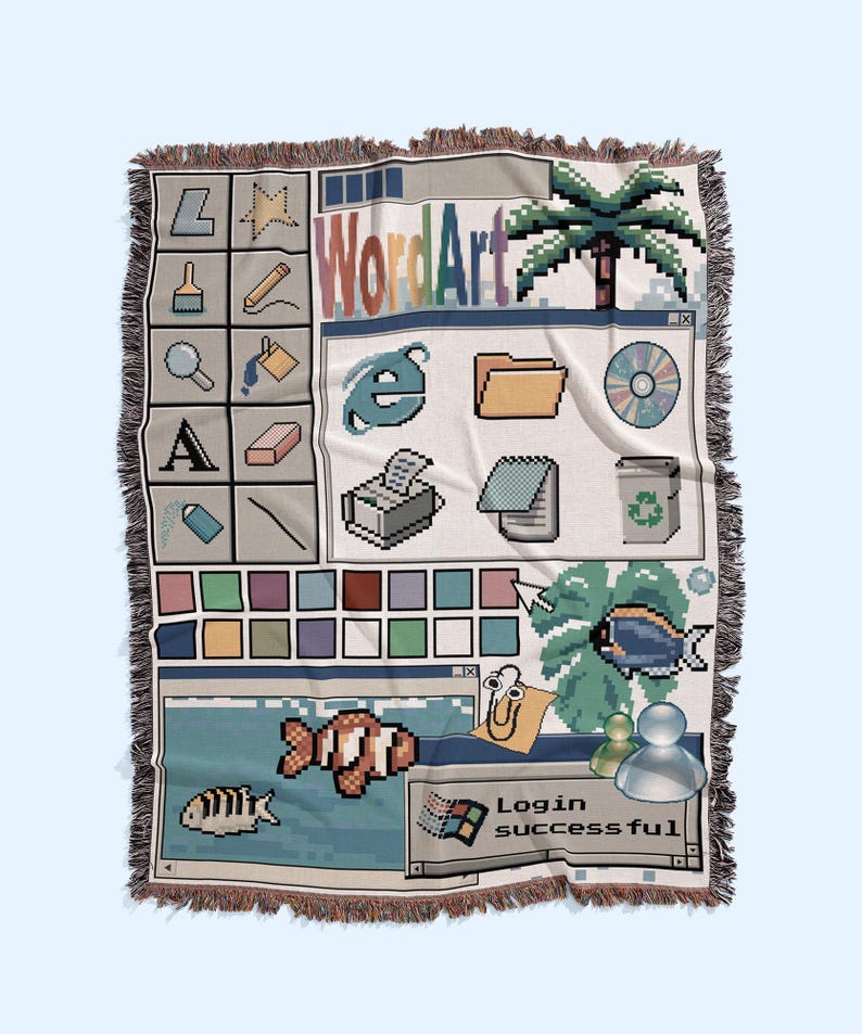 Peut inclure: Un plaid tiss&eacute; pr&eacute;sentant un design d'interface d'ordinateur des ann&eacute;es 1990. Le motif comprend des ic&ocirc;nes pix&eacute;lis&eacute;es, une palette de couleurs, un palmier, des poissons, un personnage trombone et une fen&ecirc;tre affichant le texte Login successful.