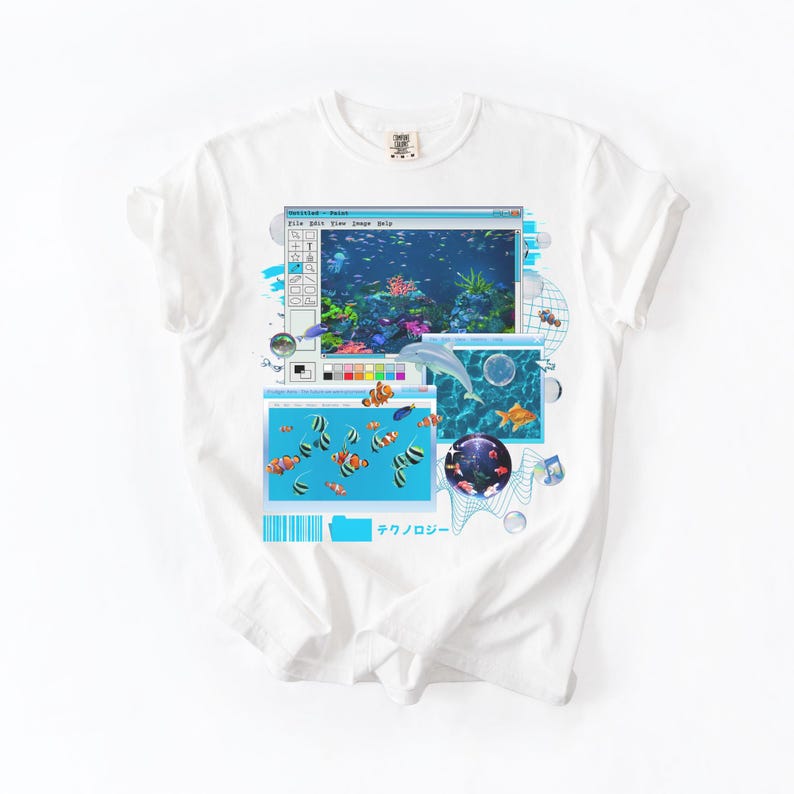 May include: White t-shirt featuring a retro-style graphic of an aquarium scene. The design includes a computer window with fish, a dolphin, and the Japanese text "テクノロジー" (technology).