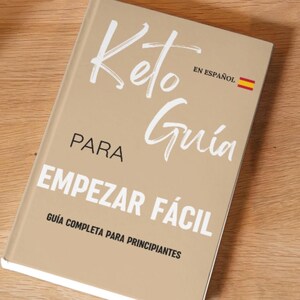 May include: A tan-colored book with the title "Keto Guía Para Empezar Fácil" in white text. The subtitle is "Guía Completa Para Principiantes" in smaller white text. The book also has the text "En Español" and a small Spanish flag.
