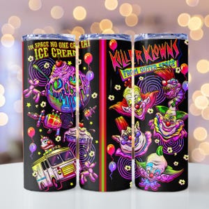May include: A black tumbler featuring colorful illustrations of clowns and ice cream. The tumbler has the text "IN SPACE NO ONE CAN EAT ICE CREAM" and "KILLER KLOWNS FROM OUTER SPACE". The design includes balloons and stars.