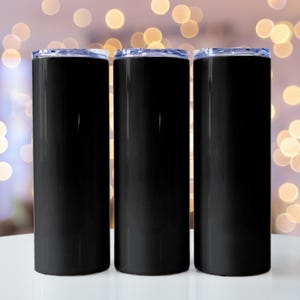 May include: Three black, cylindrical tumblers with clear lids are displayed on a white surface. The tumblers have a glossy finish and a sleek, modern design. The background is blurred with bokeh lights.