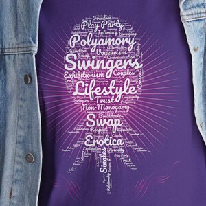 May include: Purple t-shirt with a white word cloud design. The word cloud features the words "Swingers Lifestyle" in a larger font size than the other words. The word cloud is shaped like a heart.