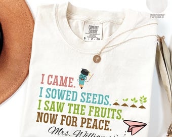 May include: Ivory t-shirt with a pencil graphic and the text "I came. I sowed seeds. I saw the fruits. Now for peace. Mrs. Williams."