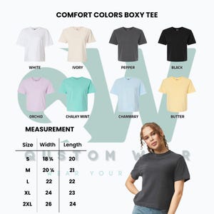 Puede incluir: Exhibici&oacute;n de camisetas Comfort Colors Boxy en blanco, marfil, pimienta, negro, orqu&iacute;dea, menta tiza, chambray y mantequilla. La imagen incluye una tabla de tallas con medidas en cm y el texto "COMFORT COLORS BOXY TEE".