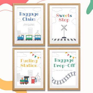 May include: Four framed prints with a light wood finish. The prints feature colorful text and illustrations related to a train theme. The text includes "Baggage Claim", "Sweets Stop", "Fueling Station", and "Baggage Drop-Off". Each print has a white background.