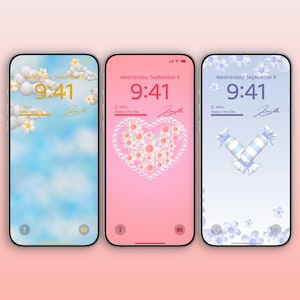 May include: Three smartphones displaying different floral-themed lock screens. The screens feature a blue sky with clouds, a pink heart made of flowers, and blue and white candies. Each screen shows the time, date, and the words "Happy Every Day."