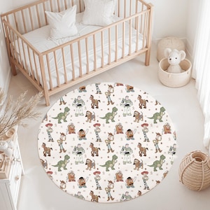 May include: A circular nursery rug with a repeating pattern of cartoon characters, including a green dinosaur, a robot, a cowboy, and a potato head. The rug is placed on a white floor in a nursery setting, with a wooden cot and other nursery decor.