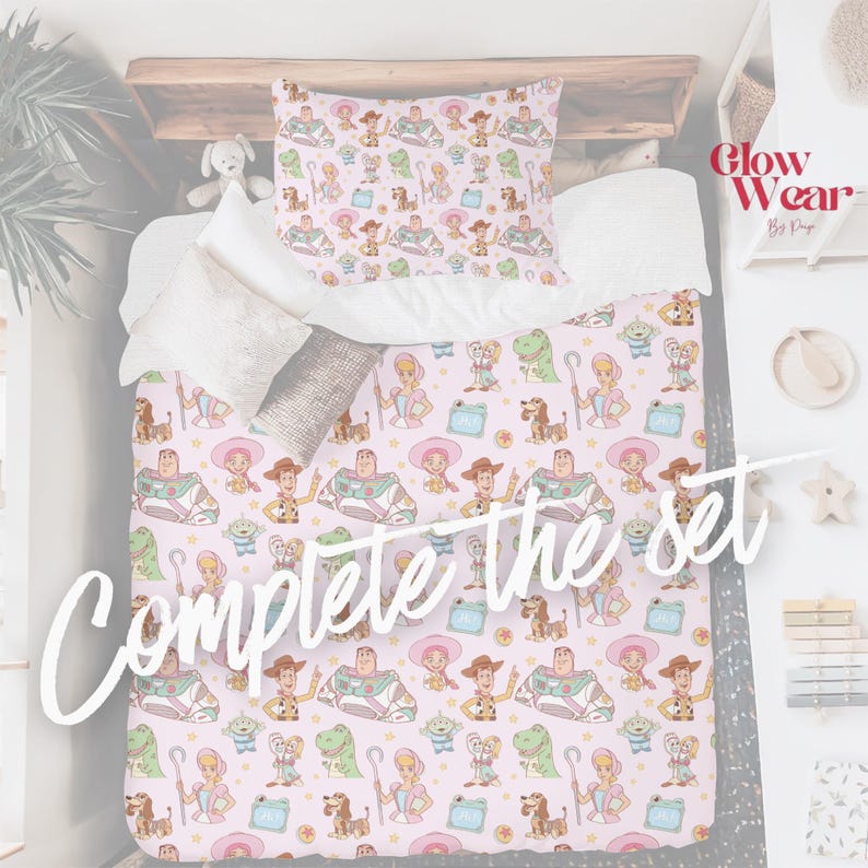 May include: A bedding set featuring a repeating pattern of Toy Story characters including Woody, Buzz Lightyear, Bo Peep, Rex, and Slinky Dog on a light pink background. The set includes a comforter and a pillowcase with the same print.