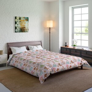 May include: A light pink comforter featuring a repeating pattern of cartoon characters including a cowgirl with a pink hat, a cowboy, a brown dog, and a green dinosaur, paired with two white pillows on a dark brown wooden bed frame.