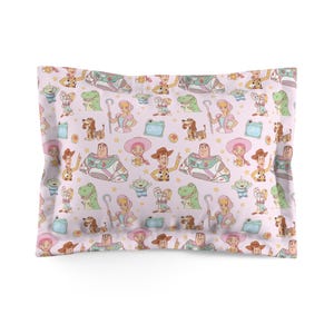 May include: A rectangular pillowcase featuring a repeating pattern of Toy Story characters including Woody, Buzz Lightyear, Bo Peep, Rex, Slinky Dog, and Forky on a light pink background with small yellow stars and light blue rectangular speech bubbles.