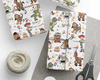 May include: Gift-wrapped presents with a white background and a colorful cartoon print featuring characters from the Toy Story movie. The gifts are tied with twine and adorned with white heart-shaped tags. A ball of twine and scissors are also visible.