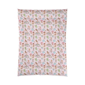 May include: A rectangular blanket featuring a repeating pattern of Toy Story characters including Woody, Buzz Lightyear, Bo Peep, Rex, and Slinky Dog on a light pink background. The design includes small stars and blue shapes scattered throughout.