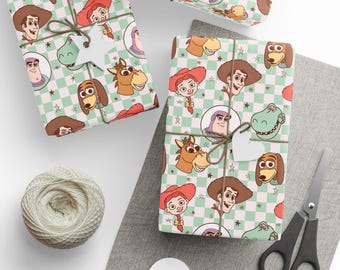 May include: Gift-wrapped presents with a cartoon character pattern. The wrapping paper features a light green and white checkered background with illustrations of characters. Each gift is tied with twine and a white tag. A ball of twine and scissors are also present.