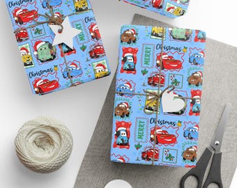 May include: Light blue wrapping paper featuring a repeating pattern of cartoon cars wearing Santa hats, candy canes, and the text Merry Christmas. The paper is tied with brown twine and white star-shaped gift tags, accompanied by scissors and yarn.
