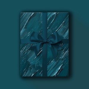 May include: A teal gift box with a textured, brushstroke design. The box is wrapped with a matching teal ribbon and a satin bow. The overall aesthetic is modern and elegant, suitable for various occasions.