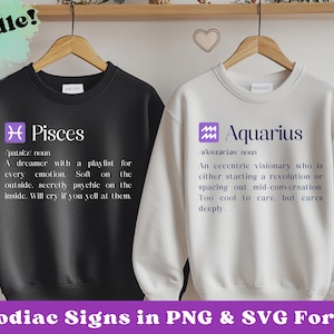 May include: Two white sweatshirts with black text and purple symbols. The text reads "Pisces" and "Aquarius" with definitions for each zodiac sign.