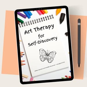 May include: A digital tablet displays a spiral-bound notebook titled "Art Therapy for Self-Discovery" with a butterfly illustration. Colored pencils and markers surround the notebook. A black stylus rests on the side.