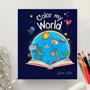 Puede incluir: Un libro para colorear para niños con una cubierta azul marino con el texto "Color my World". La ilustración incluye un globo azul con un sol, un globo aerostático y otros dibujos coloridos. El libro está abierto, revelando un lomo rosa.