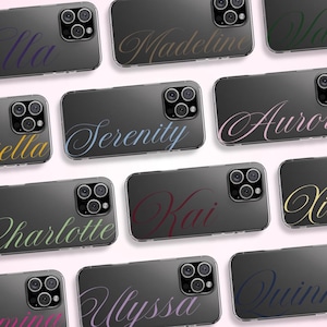 May include: A collection of clear phone cases with names in a cursive font. The names include "Serenity", "Aurora", "Kai", and others, each in a different color gradient. The cases have a dark gray back and a clear border.