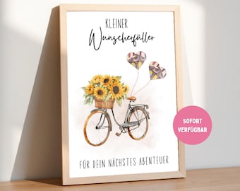 May include: Watercolor print in a wooden frame featuring a bicycle with a basket of sunflowers. Two heart-shaped balloons float above the bike. The text reads "Kleiner Wunscherfüller" and "Für dein nächstes Abenteuer".