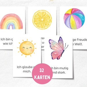 Könnte beinhalten: Ein Set von 32 Aquarell-Affirmationskarten. Jede Karte zeigt eine farbenfrohe Illustration, darunter ein Regenbogen, eine Zitronenscheibe, ein Strandball, eine lächelnde Sonne und ein Schmetterling. Text auf Deutsch ist sichtbar.