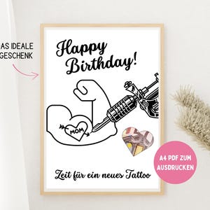 May include: A framed print with a black and white tattoo-themed design. The artwork features a muscular arm with a heart tattoo that says "MOM", a tattoo gun, and the words "Happy Birthday!" and "Zeit für ein neues Tattoo".