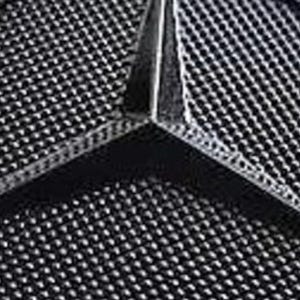 May include: A close-up of a black, three-pointed star logo with a textured surface.