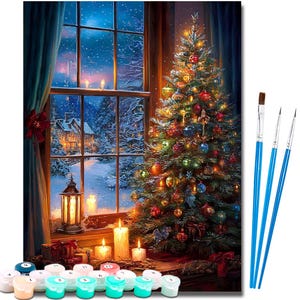 May include: A paint-by-numbers kit featuring a Christmas scene. The image shows a decorated Christmas tree next to a window overlooking a snowy landscape. Candles, gifts, and paint pots are in the foreground, with paintbrushes on the right.