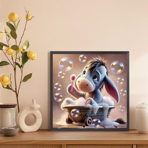 May include: A blue cartoon donkey sits in a white bathtub with pink soap bubbles floating around it. The donkey is holding a pink wand and blowing bubbles. The background is a light brown color with more bubbles.