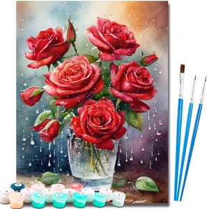May include: A paint-by-numbers kit featuring a watercolour painting of red roses in a glass vase. The painting has water droplets and includes paint pots and blue-handled paintbrushes. The roses are in full bloom.