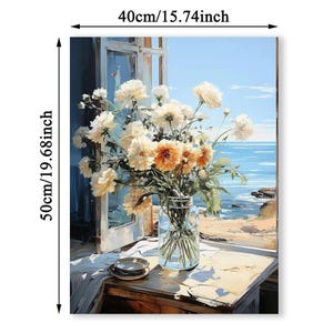 May include: A floral canvas print depicting a vase of white and orange flowers on a table near a window. The artwork is 19.68 inches tall and 15.74 inches wide. The background shows a seascape with a blue sky and ocean.